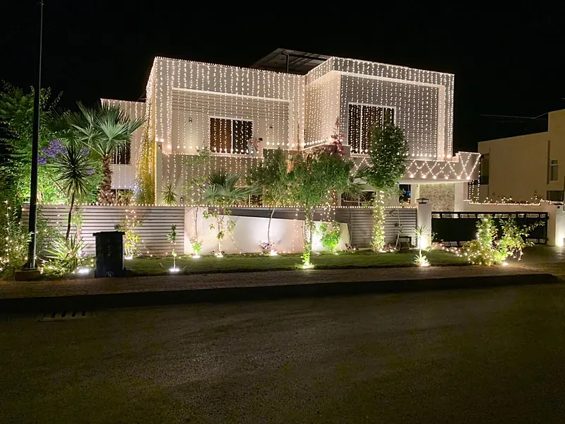 Wedding house lighting on a two-storey house at night